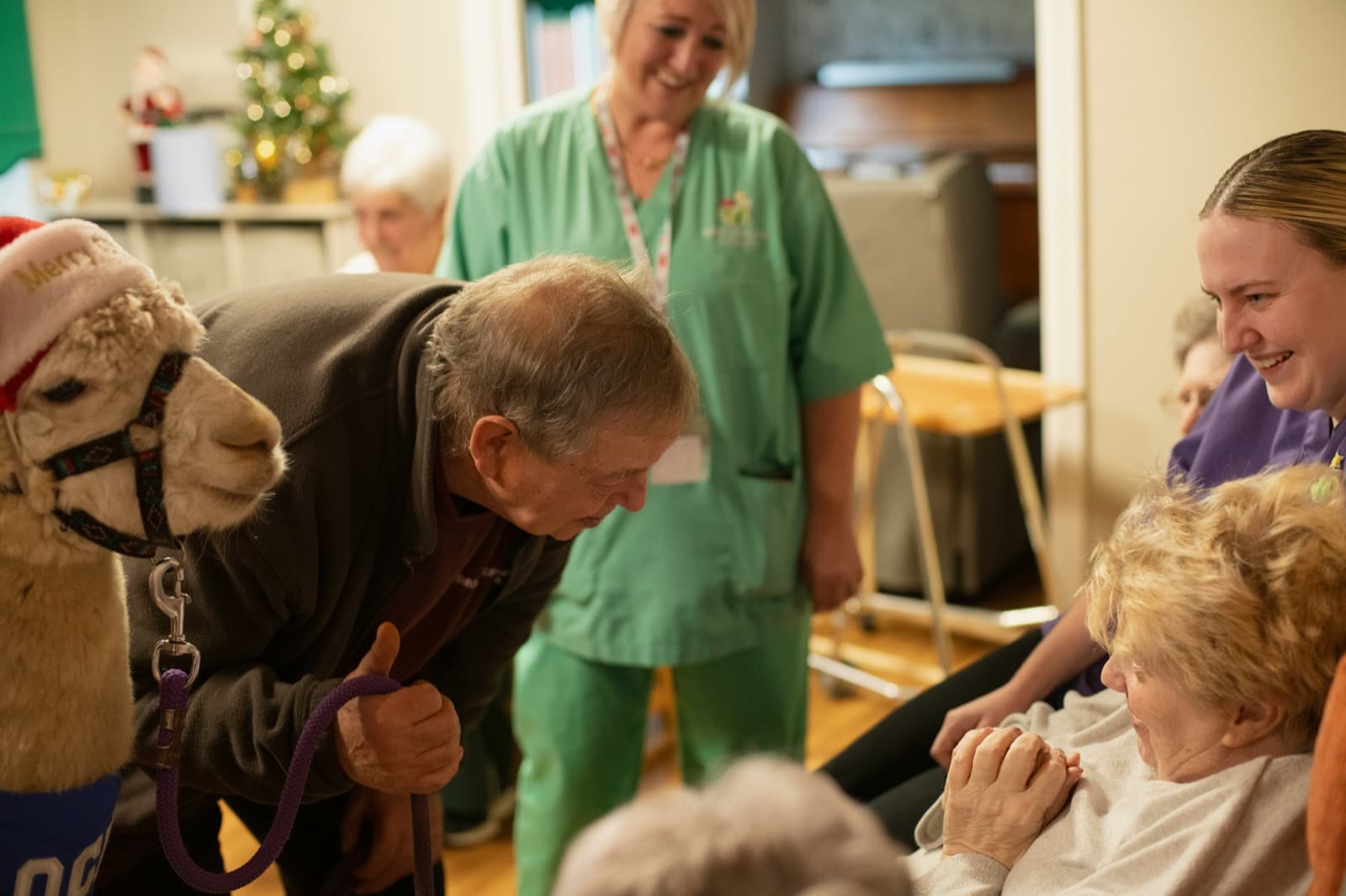 Care team and residents sharing a warm moment in a care environment.