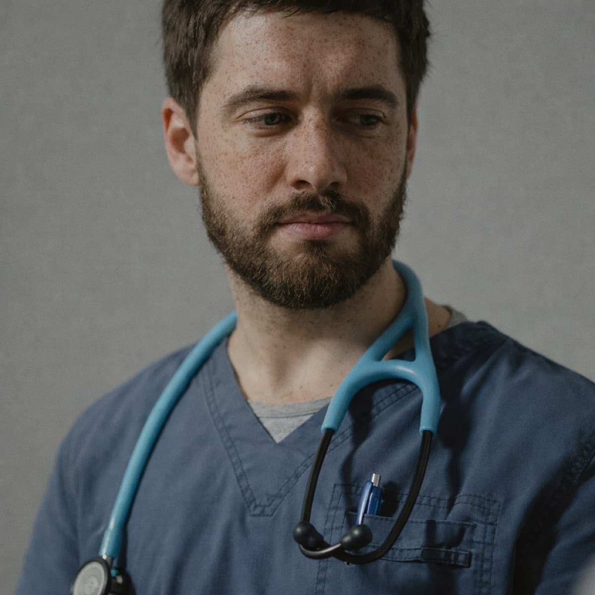 Healthcare professional in scrubs with a stethoscope for Rosebud's support worker and care assistant article.