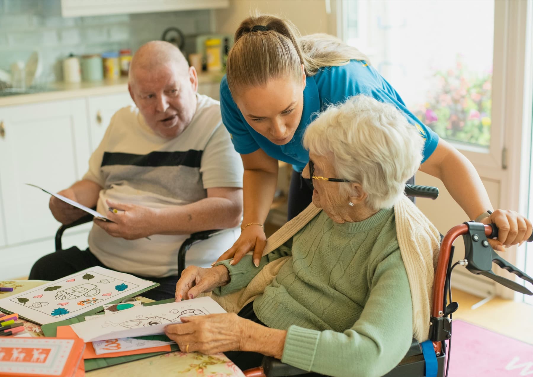 Care worker supporting an older adult in a comfortable care setting.